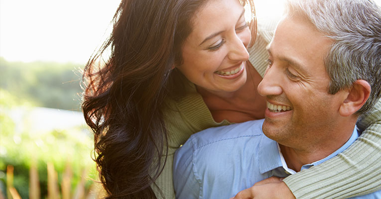 man and woman smiling together