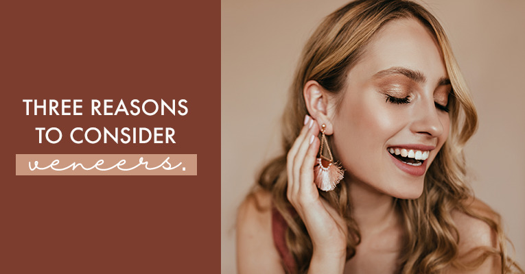 woman smiling with earrings and white smile