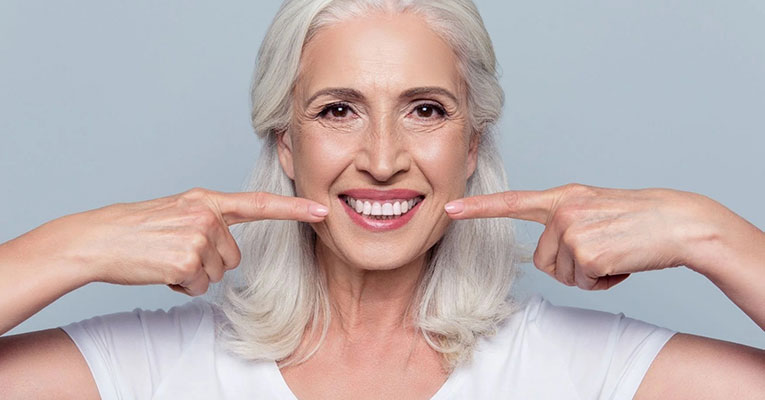 elderly woman smiling about dental implants