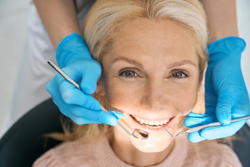 Lady at dentist office smiling.