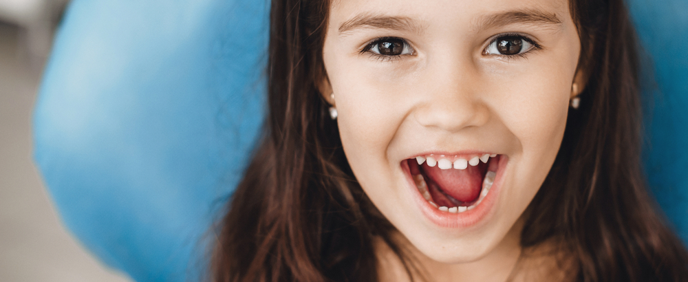 child smiling at dentist